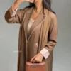 woman taking picture while wearing brown abaya and shela