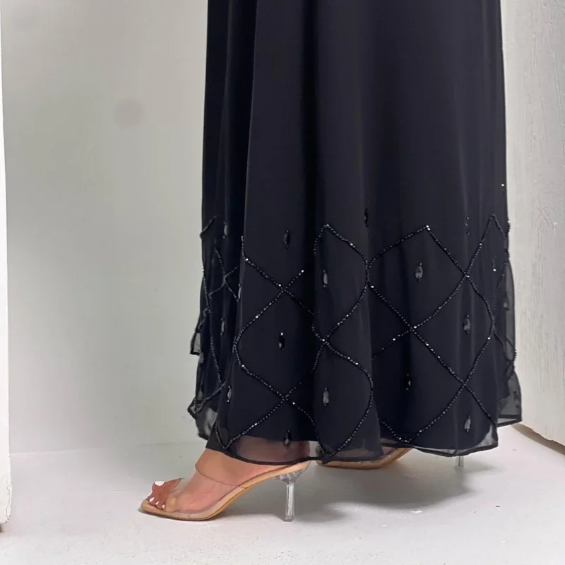 woman wearing abaya with beads