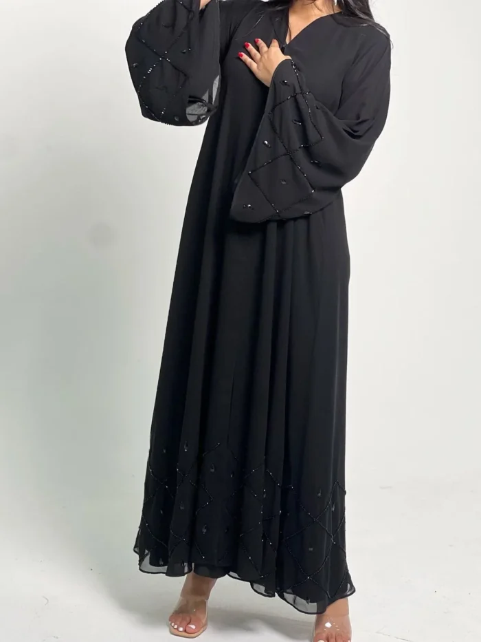 woman wearing abaya with beads